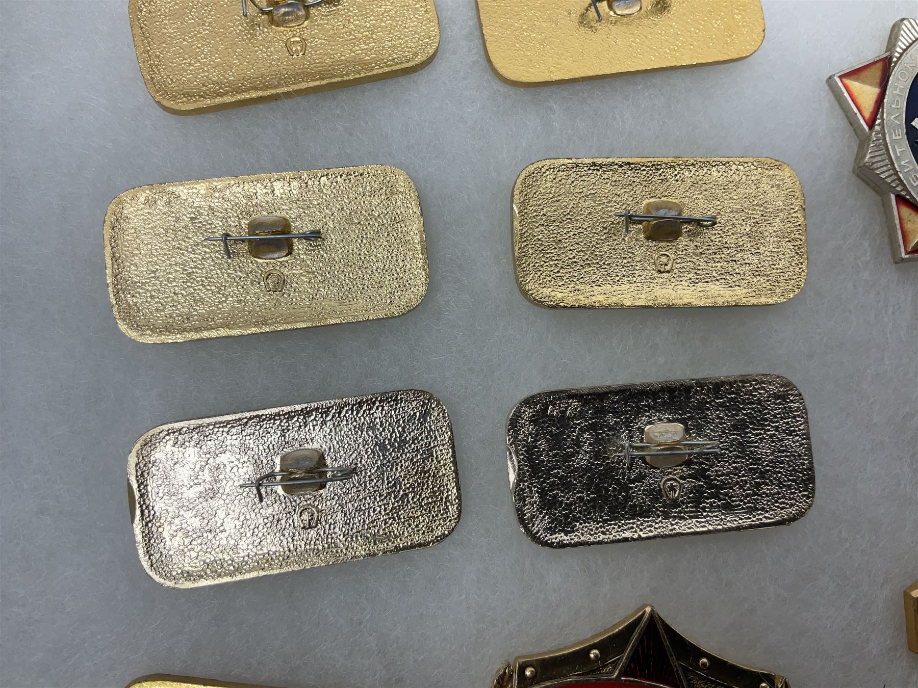 Nineteen Russian Soviet Tank Commemoration badges and medals, in small display case