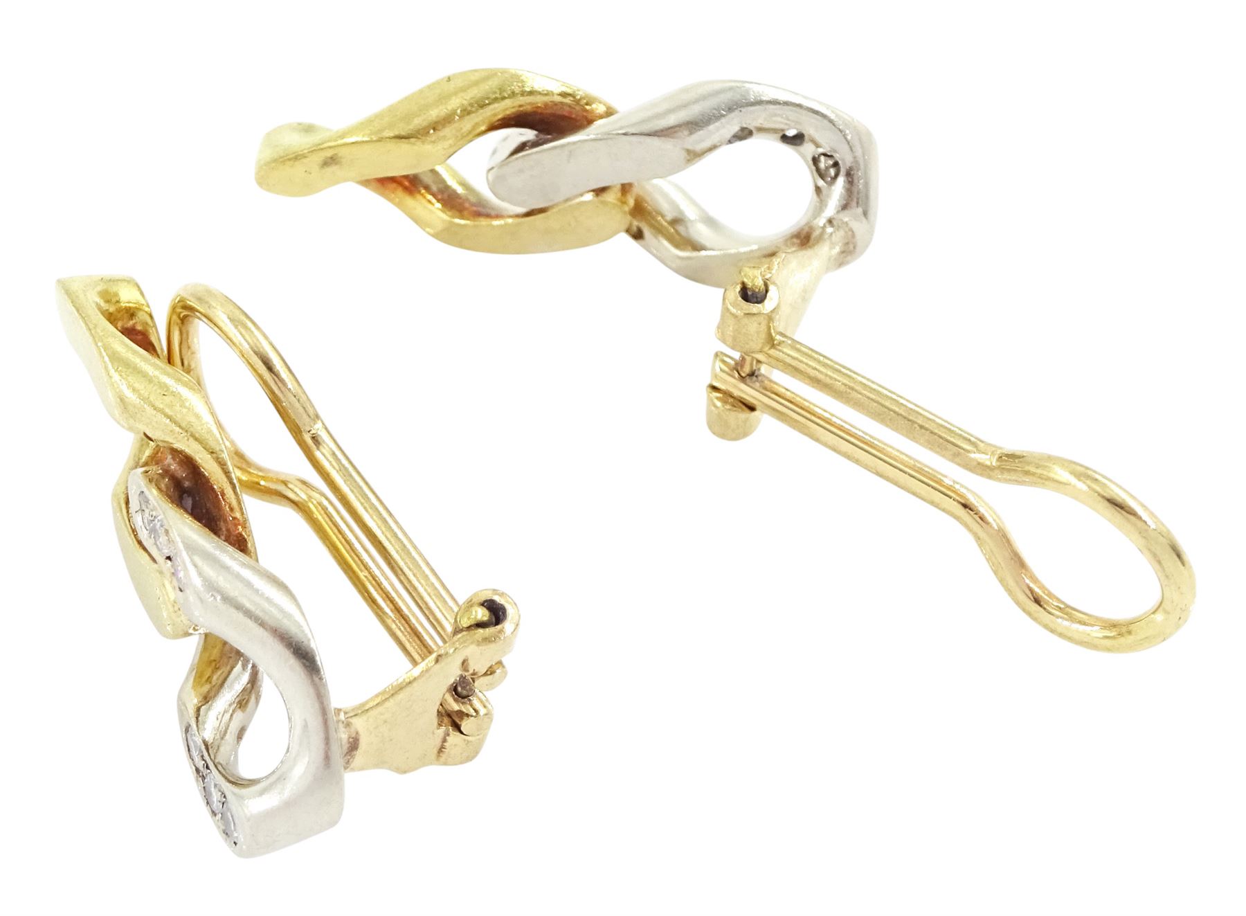 Pair of gold diamond earrings, each clip back with yellow gold curb link, suspending a diamond set white gold curb link