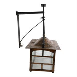 20th century, Arts and Crafts style copper porch lantern, of rectangular form, with cast iron scrolling wall fittings