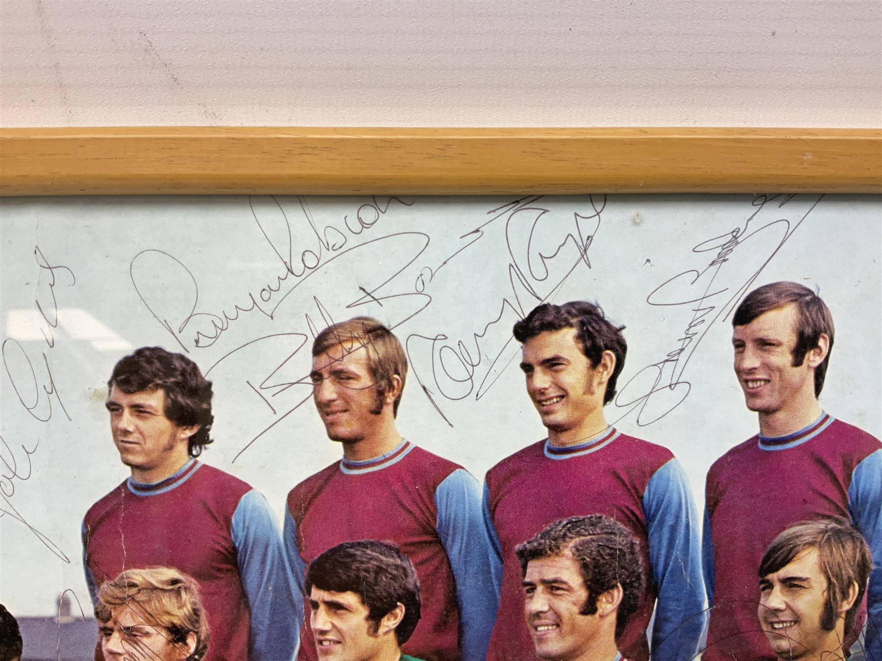 1970-1 photograph of West Ham United FC squad members, including Bobby Moore, Geoff Hurst, Harry Redknapp, Trevor Brooking, Jimmy Greaves, Billy Bonds etc, most players with signatures, 30 x 45cm, framed and glazed