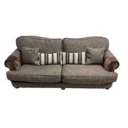 'Canterbury' Grande four seat sofa upholstered in brown fabric with contrasting textures, traditional shape with scrolled arms and studded bands, on turned feet (two sectional)