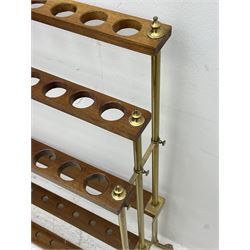 Late 20th century three tier brass and mahogany stick stand, thirty-six stick capacity, on splayed brass feet, turned finals 
