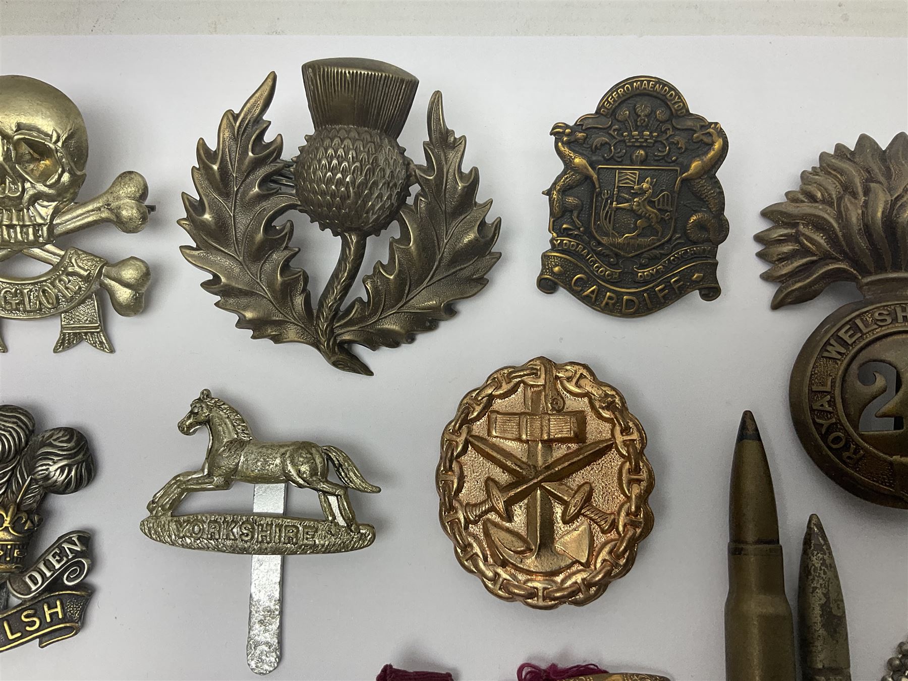 Two Edwardian hallmarked silver presentation fobs for military bugling competitions; and quantity of cap/glengarry and other badges, sweetheart brooches etc