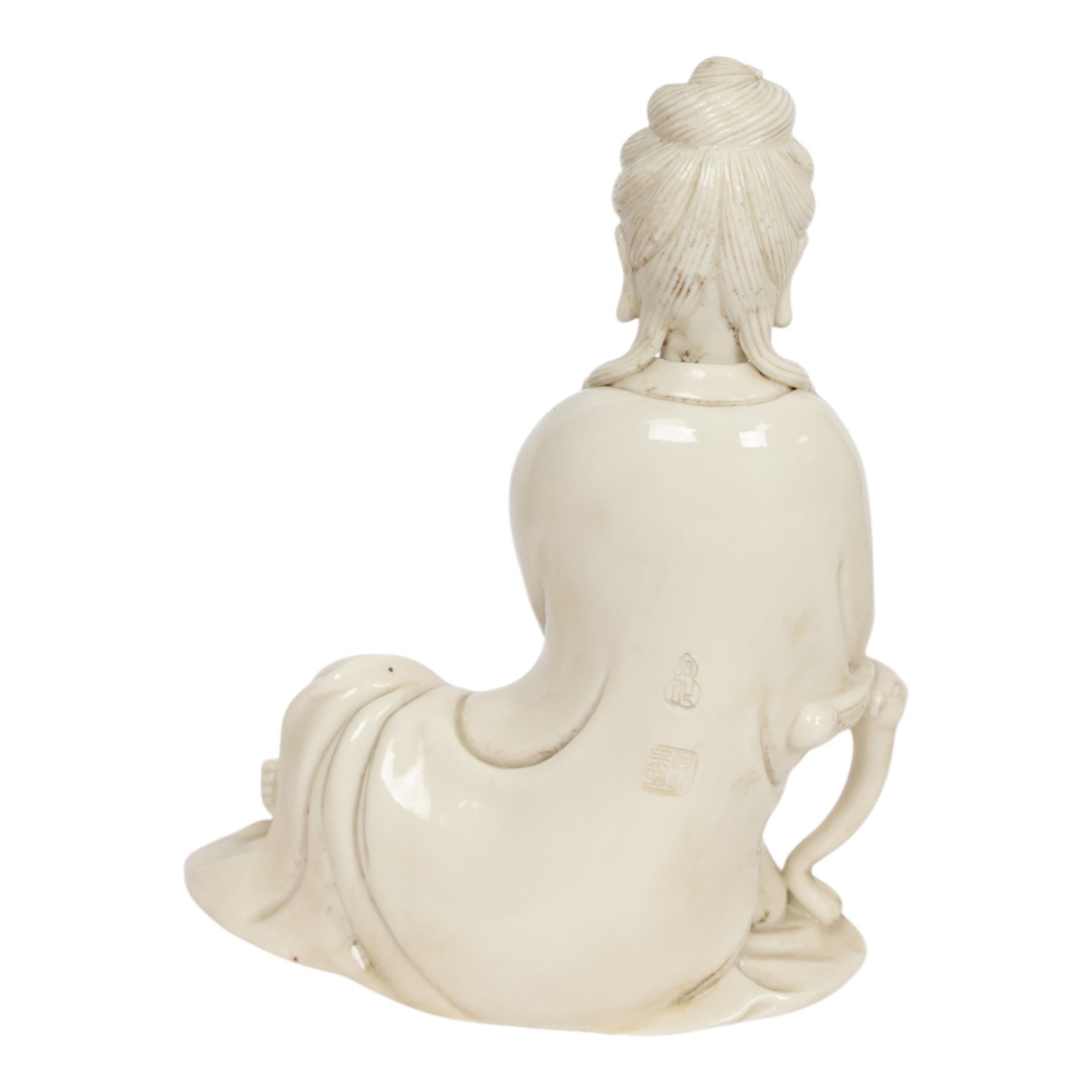 Three Chinese blanc de chine, each depicting Guanyin seated, Dehua province, two with double gourd and potters seal marks to the reverse 
