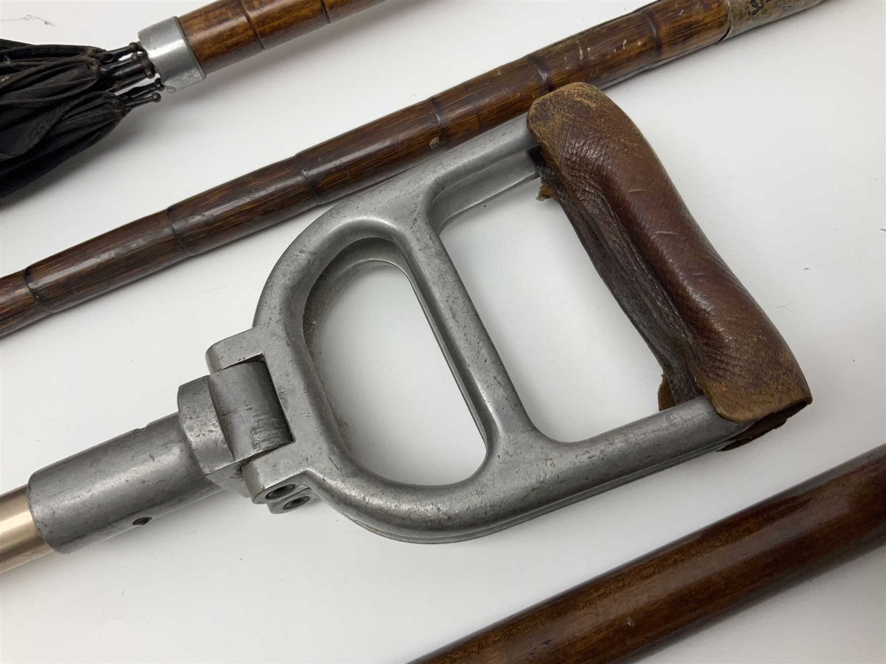 Early 20th century curved horn handle walking stick with hallmarked silver mounts, engraved L Russell 1918, together with a shooting stick by William Mills Birmingham, with leather handle, 'The Featherwaite' shooting stick and an umbrella with wooden handle