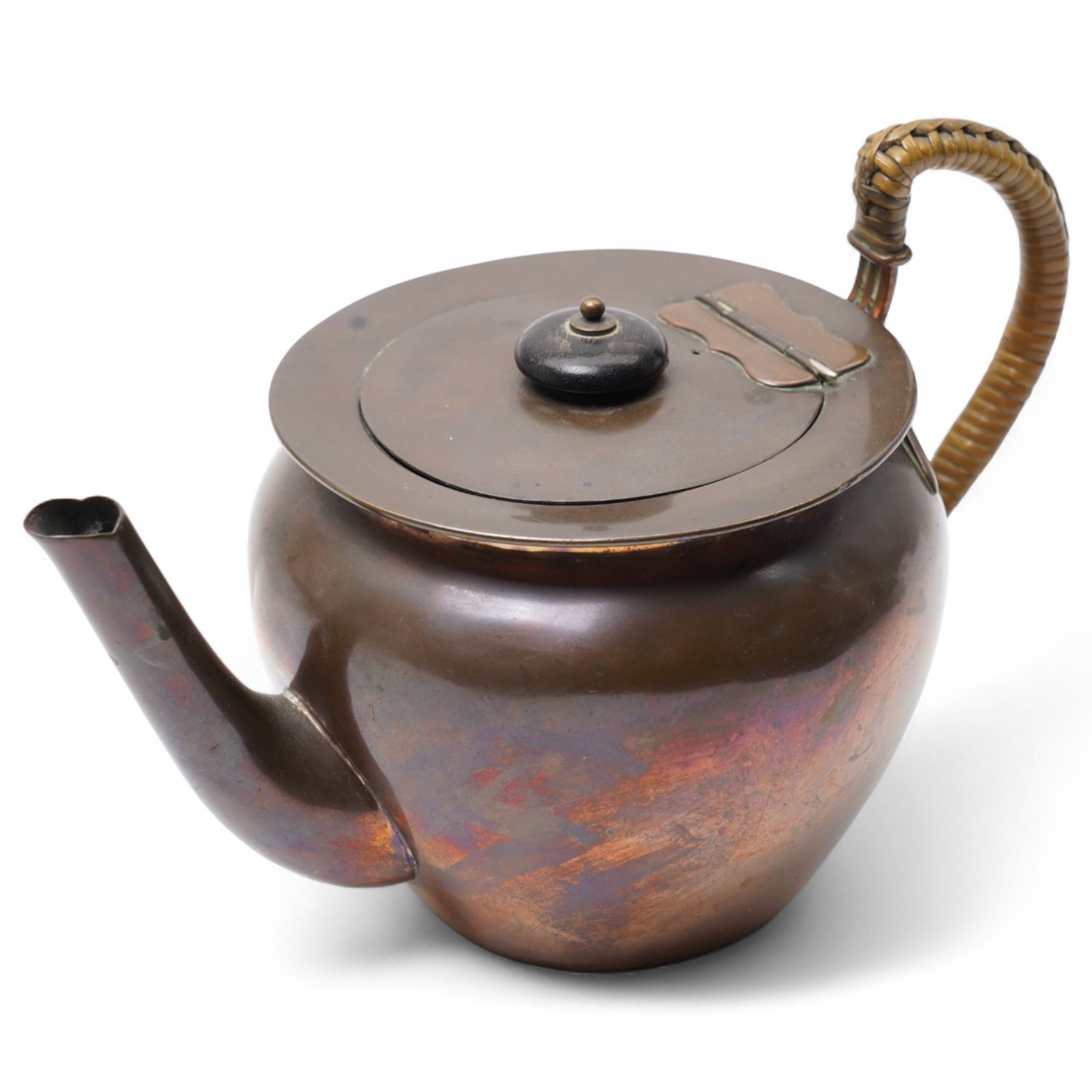 Keswick School of Industrial Arts copper teapot, stylised form with cane wrapped handle, stamped to base KSIA, H13cm 