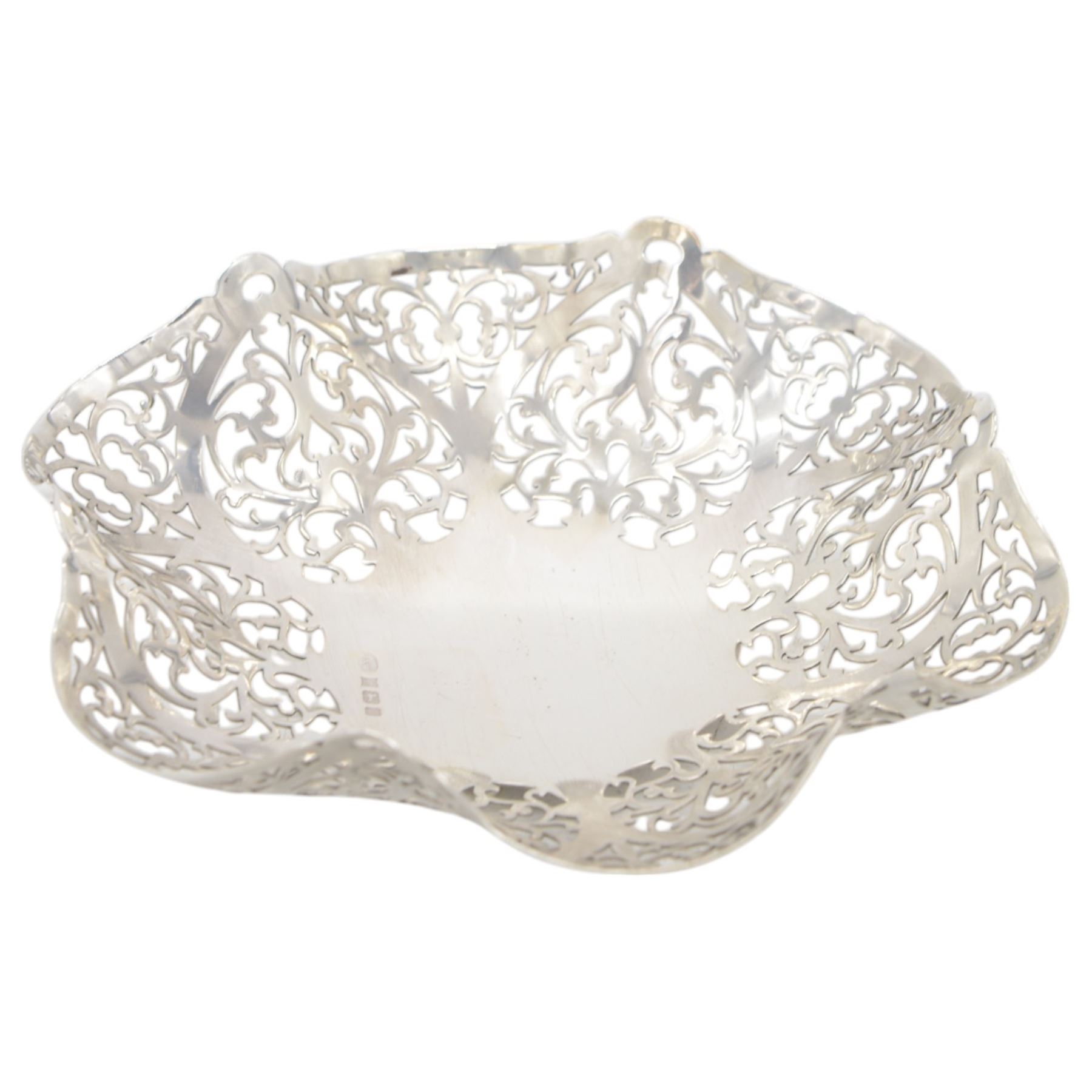 Mid 20th century silver bowl, of hexagonal form with scrolling pierced sides, upon three bun feet, hallmarked W I Broadway & Co, Birmingham 1962, W18cm