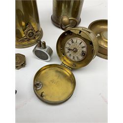 Quantity of brass trench art to include a WWI shell case in the form of a miniature coal scuttle with a Royal Artillery cap badge mounted to the body, three trench art lighters, 1980 Falkland ash tray, cased clock etc