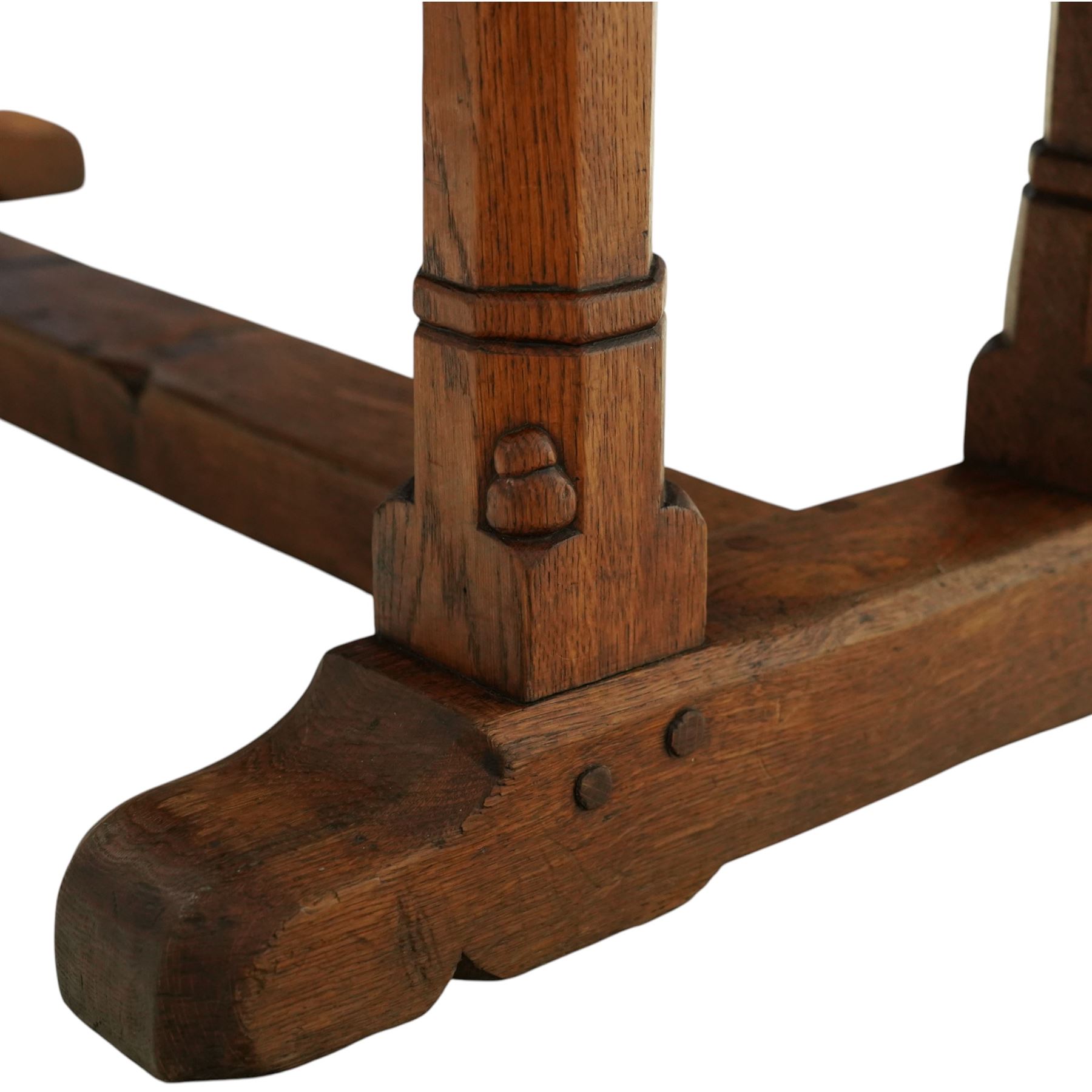 Mouseman - 1937 refectory table, Sir Herbert Baker commission for Westminster Church House, the rectangular adzed plank top above twin octagonal baluster supports united by a pegged stretcher, raised on shaped sled bases carved with a partridge and a loaf of bread, with carved mouse signature to inside leg, by Robert Thompson of Kilburn

The carved loaves reference the original patron, while the partridges are thought to represent Frank Partridge, Bishop of Portsmouth from 1877 to 1941, who played a key role in the founding of Church House and served as its Secretary from 1936 until 1941

Reference
Christie’s ROBERT “MOUSEMAN” THOMPSON; Refectory Table, Lot 188, sold at Christie’s London, commissioned by Sir Herbert Baker KCIE, RA, architect of Church House (opened 1937). Provenance and description available on the Christie’s website
https://www.christies.com/en/lot/lot-4618786