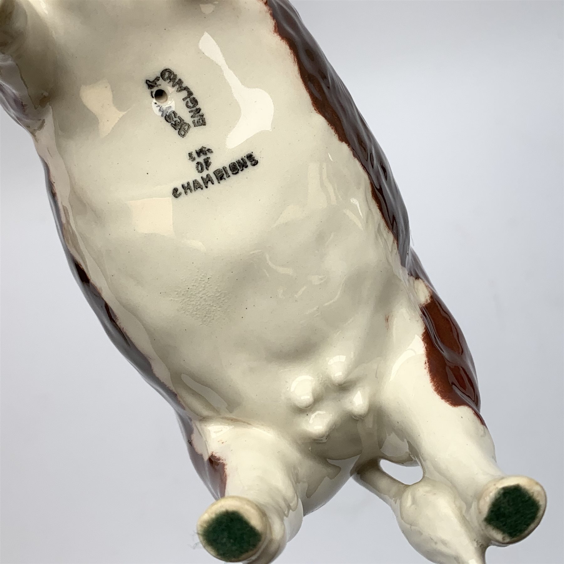 A Beswick Hereford Bull, Hereford Cow, and Hereford Calf, each with printed mark beneath, Bull and Cow marked CH of Champions. 