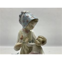 Lladro figure, Feeding Her Son, modelled as a mother bottle feeding her baby boy, sculpted by Vincente Martinez, with original box, no 5140, year issued 1982, year retired 1991, H23cm
