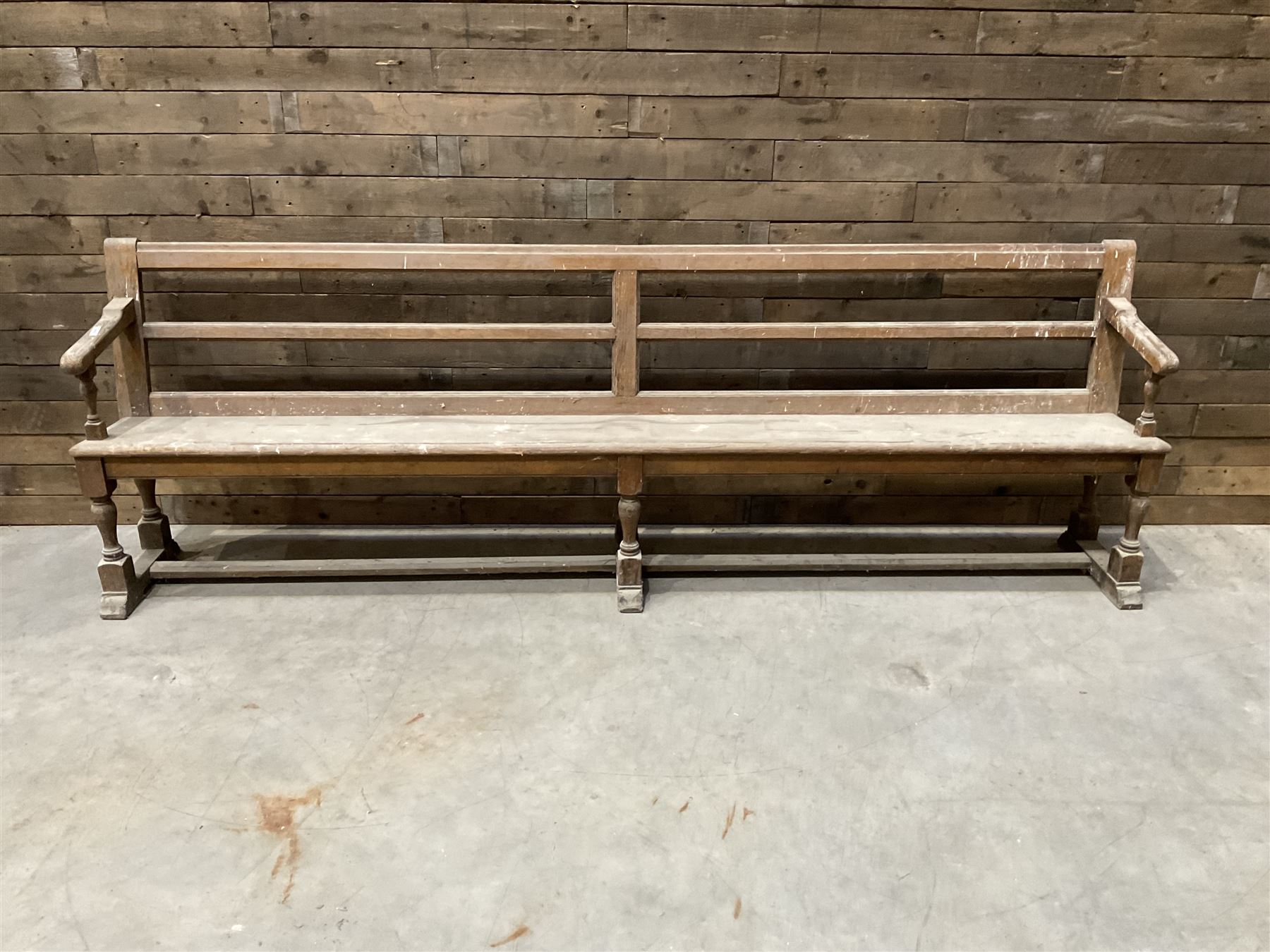 Victorian pitch pine bench pew, turned arms and legs, rail back with plank seat, 274cm