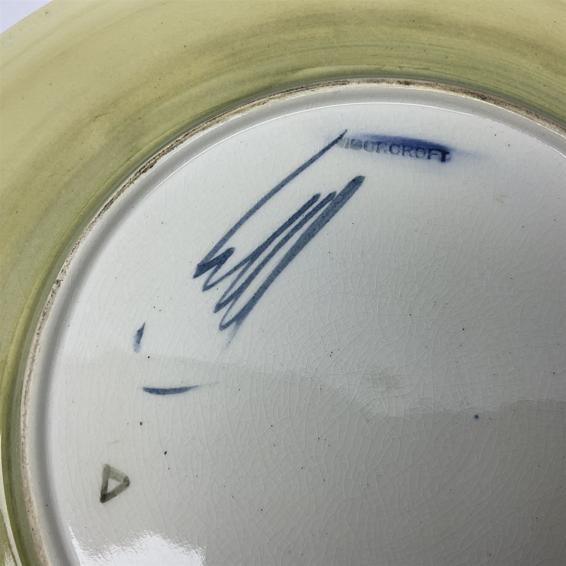 Moorcroft Tiger Lily pattern plate on a yellow ground, with painted and impressed mark beneath, D26cm