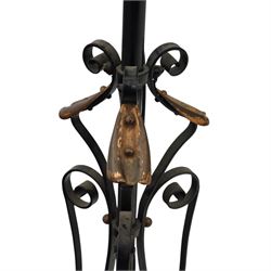 Early 20th-century Art Nouveau style standard lamp, wrought iron scrolled tripod base with copper foliate terminals supporting a brass oil reservoir surmounted by an opaline glass globe shade with spiral patterning, wired for electricity, untested 