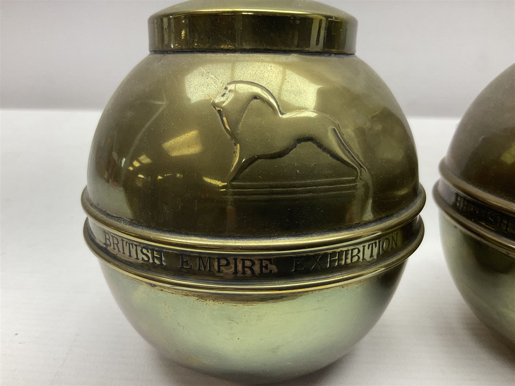 Pair of brass 1924 commemorative tea caddies, of ovoid form the waist embossed with 'British Empire Exhibition 1924' 'Lipton's Souvenir Tea Caddy', H18cm