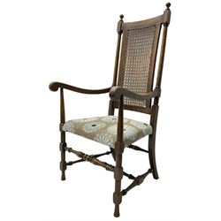 Early 20th century beech framed armchair, upholstered seat and cane back, on turned and block supports united by turned stretchers 