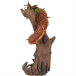 Modern Chinese root carving, modelled as a dragon wrapped round a tree, the dragon painted in greens and reds, H70cm