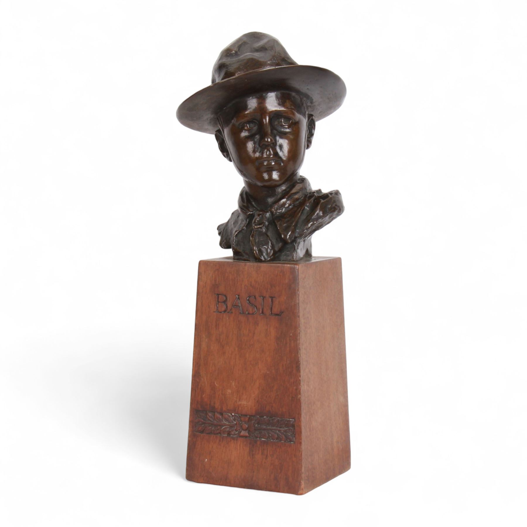 William Goscombe John (Welsh 1860-1952), bronze, bust of Basil Webb as a boy scout, upon a tall oak plinth inscribed BASIL above foliate band, titled to paper label verso and beneath, overall H36cm
