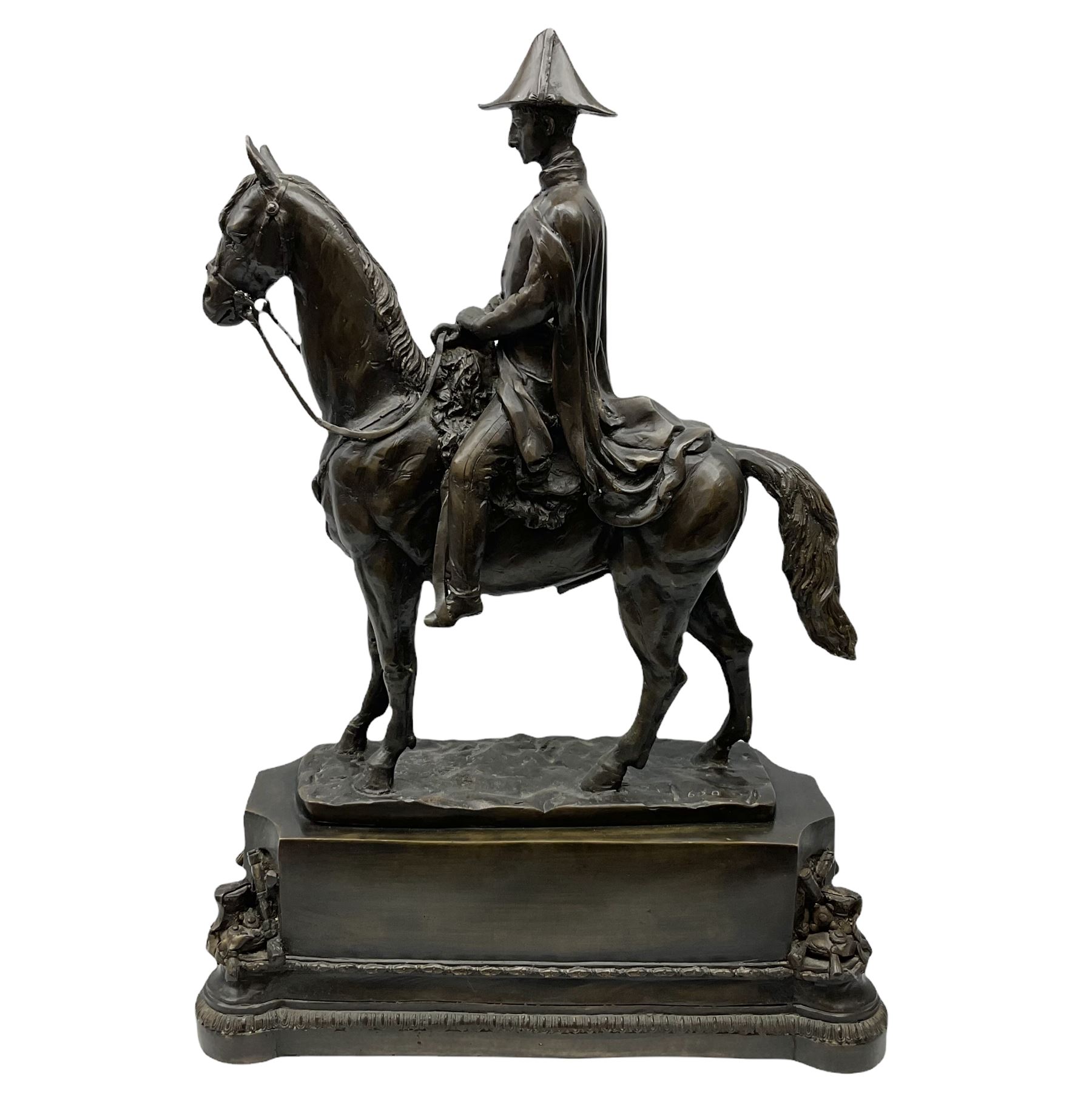 Large and impressive bronze figure of Wellington seated on a horse, on a sarcophogus shaped stepped base impressed 'Meunier Paris', the canted corners inset with battle trophies H68cm L50cm D22cm