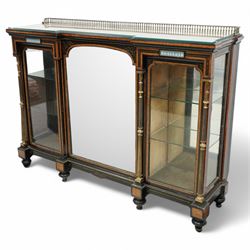 Victorian amboyna and ebonised credenza with glass top, the freeze fitted with two Wedgewood plaques and brass beading above crossbanded arched glazed mirror door flanked by two glazed cabinet doors with two removable glass shelves between four gilt brass reeded floral columns, supported on bun style feet