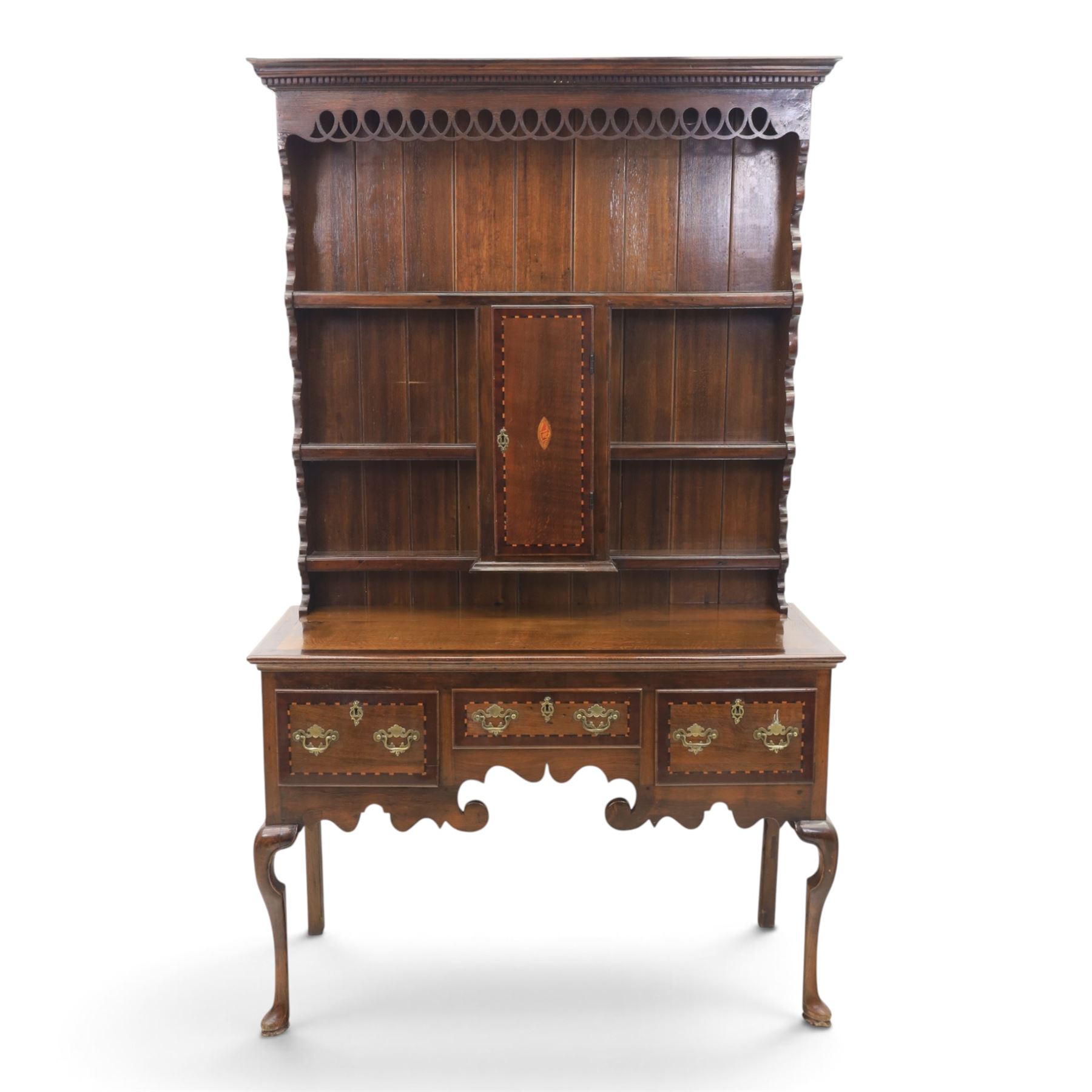 Late 19th century inlaid oak dresser and plate rack, plate rack with projecting cornice and fretwork, with three shaped shelves for plates, central cupboard with inlaid shell and border, brass escutcheon and key, the lower section with crossabanded top, above three drawers with brass handles and inlaid border, shaped apron raised on cabriole supports 
