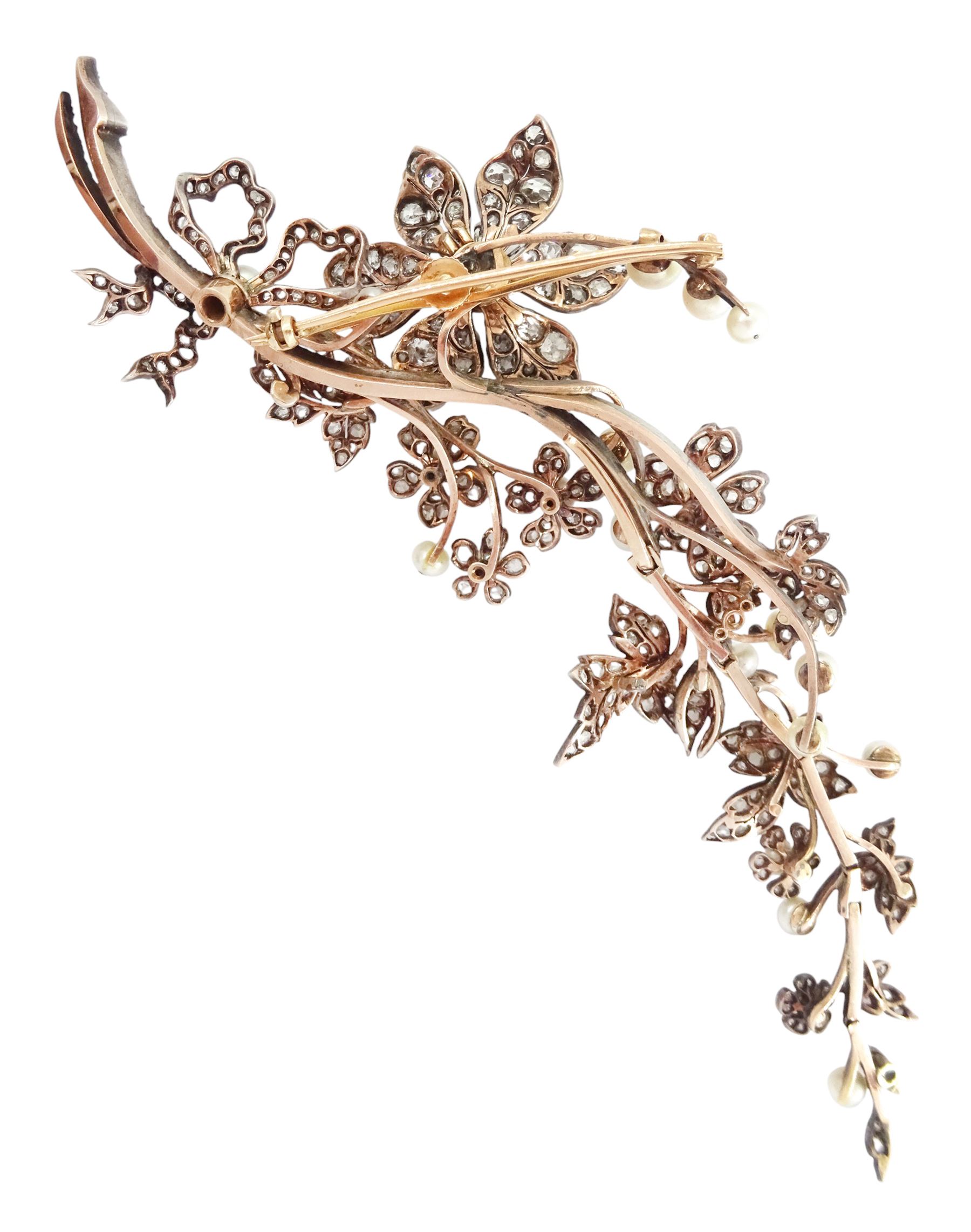 19th century gold and silver diamond and pearl en tremblant detachable brooch, the flower tremblant with a principal old cut diamond of approx 1.90 carat, the petals and stamen set with old cut and rose cut diamonds, total diamond weight approx 9.10 carat, to a foliate spray set set with further rose cut diamond and white / pink / cream pearls and ribbon tie