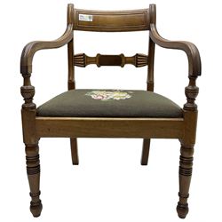 Regency mahogany elbow chair, carved shaped central back bar, over drop-in seat upholstered in floral needlework, raised on ring turned front supports