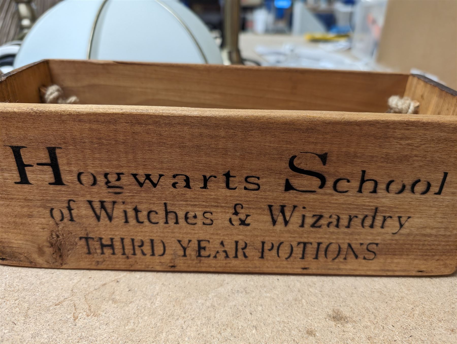 Two pairs of table lamp bases, with two glass shades and two fabric shades, together with a wooden 'Hogwarts' box and dumbbells