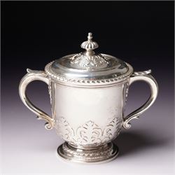 Silver two handled cup and cover with loop handles, raised stylised leaves and gadrooned e...