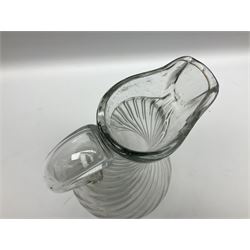 Early 19th century Continental soda glass jug, the wrythen bulbous body with thick rim and lip and hollow curved handle, upon a circular foot, H28.5cm