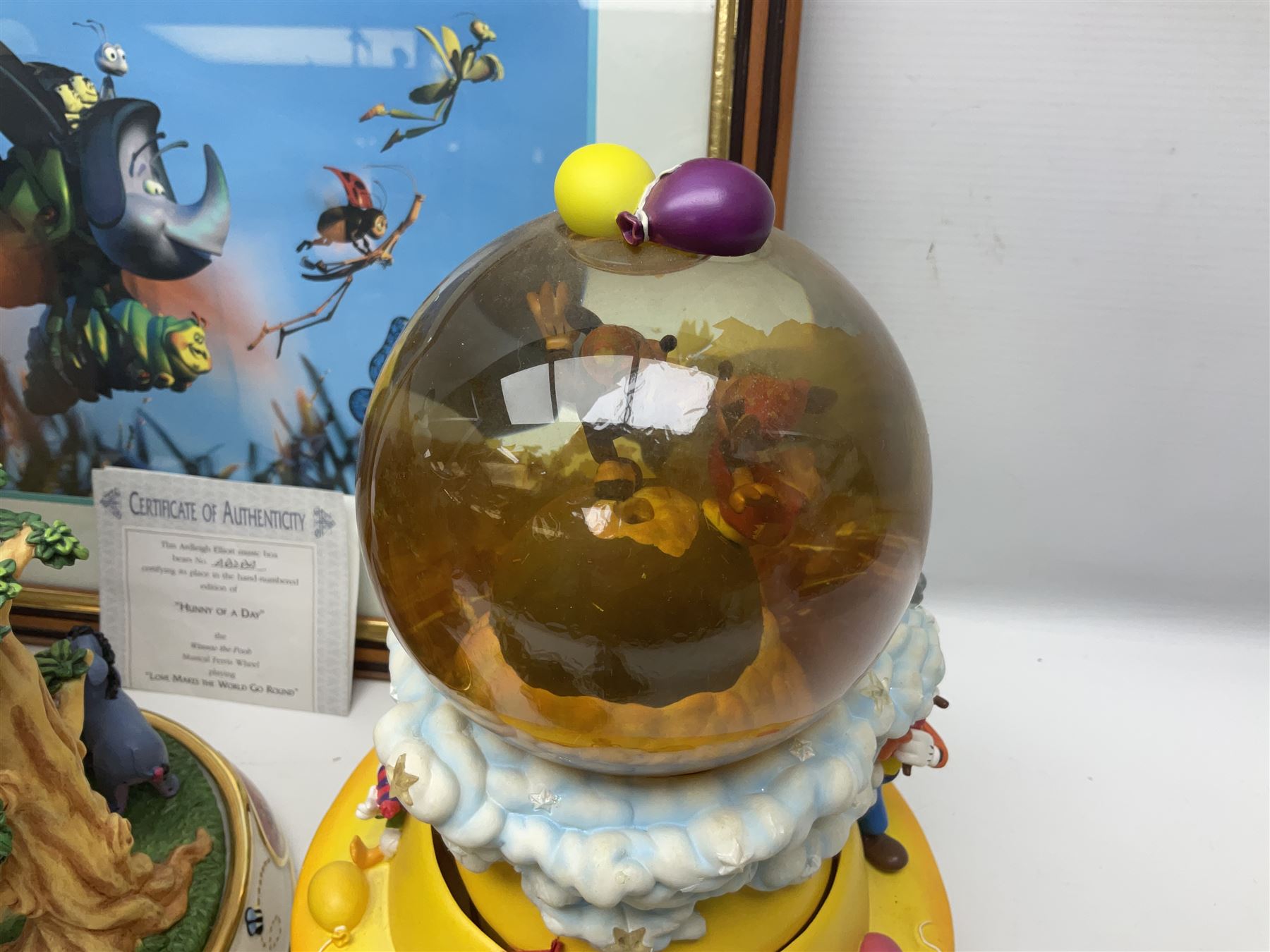 Collection of Disney figures, to include Ardleigh Elliott music box Hunny of the Day, Disney musical snow globe, Micky mouse lazy butler, Framed Bug's Life lithograph etc 