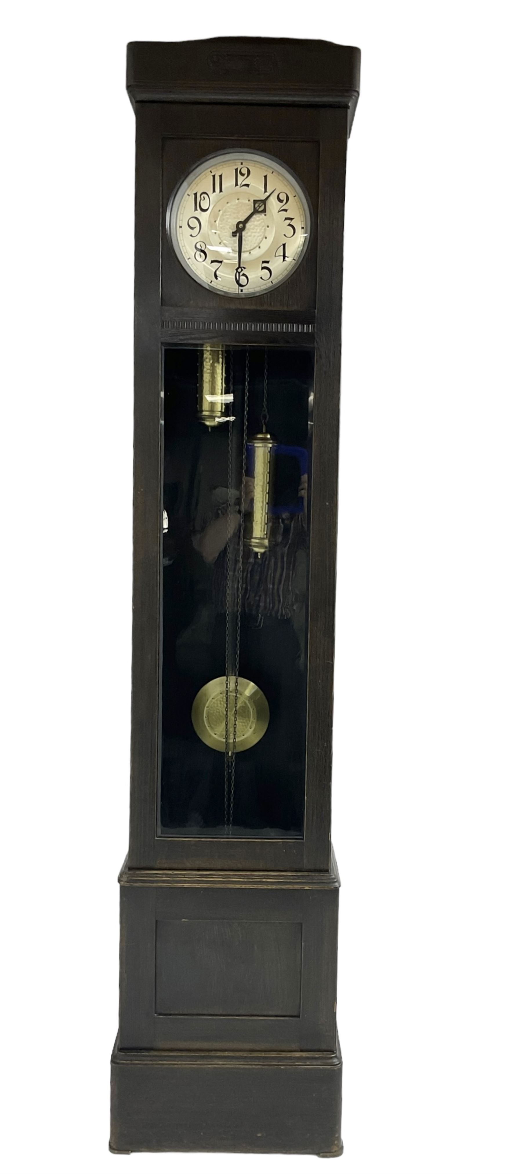 20th century Art Deco- oak cased 8-day longcase clock c1930, flat topped case with a fully glazed door on a stepped plinth, silvered circular dial with Arabic numerals and pierced steel hands, chain driven twin train movement with  4 gong rods. With pendulum and two brass cased weights.