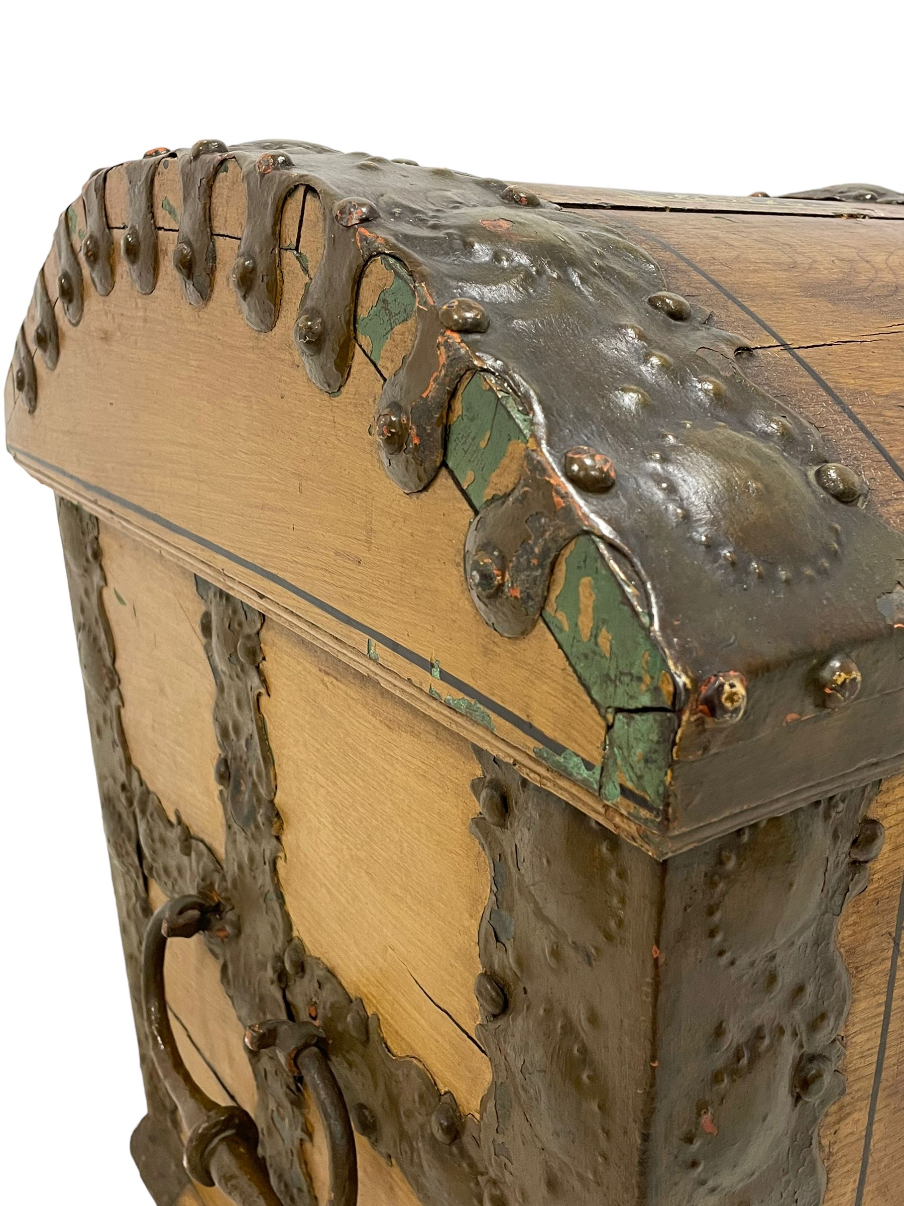 19th century painted oak sea chest, hinged dome top enclosing small compartment, bound by shaped and pressed metal strapwork, scumbled finish to resemble oak and painted with small vignettes depicting portraits and landscapes within panels, fitted with large wrought metal carrying handles, the front inscribed 'H.J.S. 1870' 