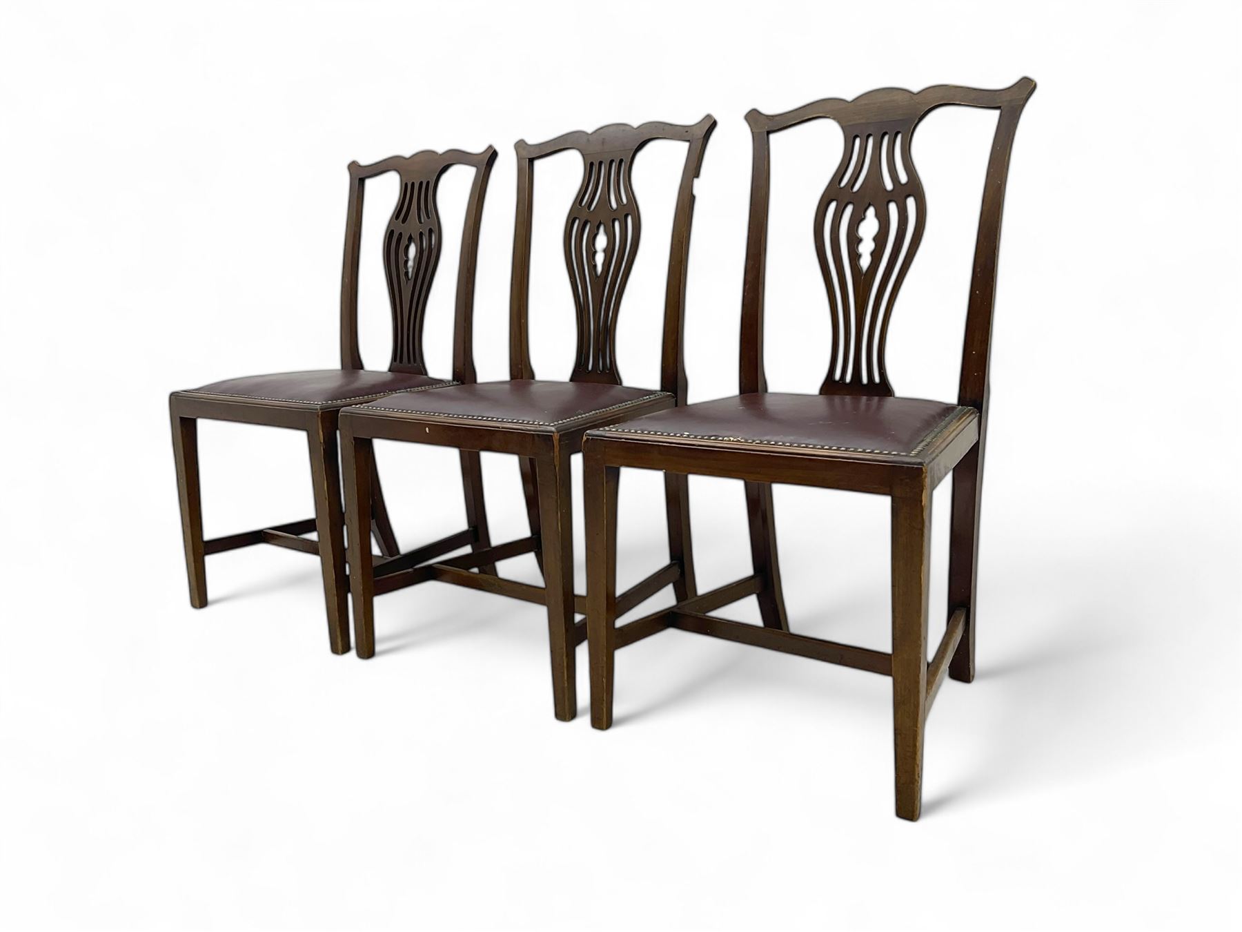 Set of six (4+2) 19th century Chippendale-design mahogany dining chairs, shaped cresting rail over pierced bulbous vase-shaped splat, burgundy leather upholstered seats with brass stud trim, on square tapering supports united by H-stretchers