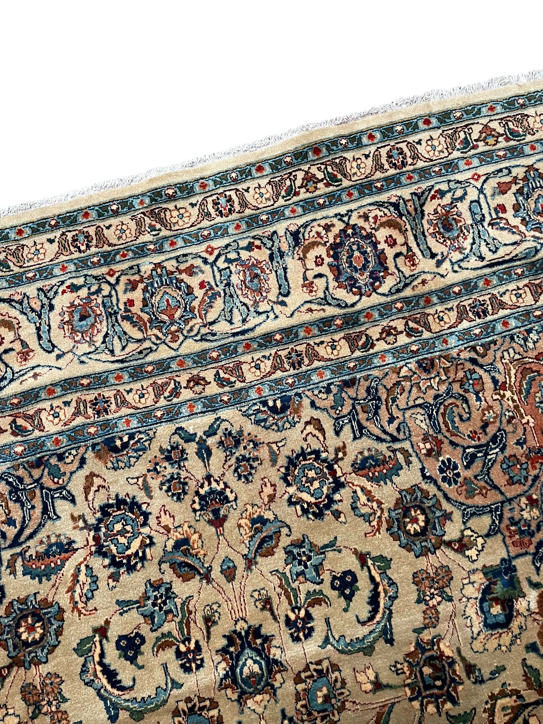 Persian Kashmar camel ground carpet, palmette rosette medallion on a field of curling leafy branches and stylised plant motifs, scrolling border decorated with further palmettes, within floral pattern guard stripes