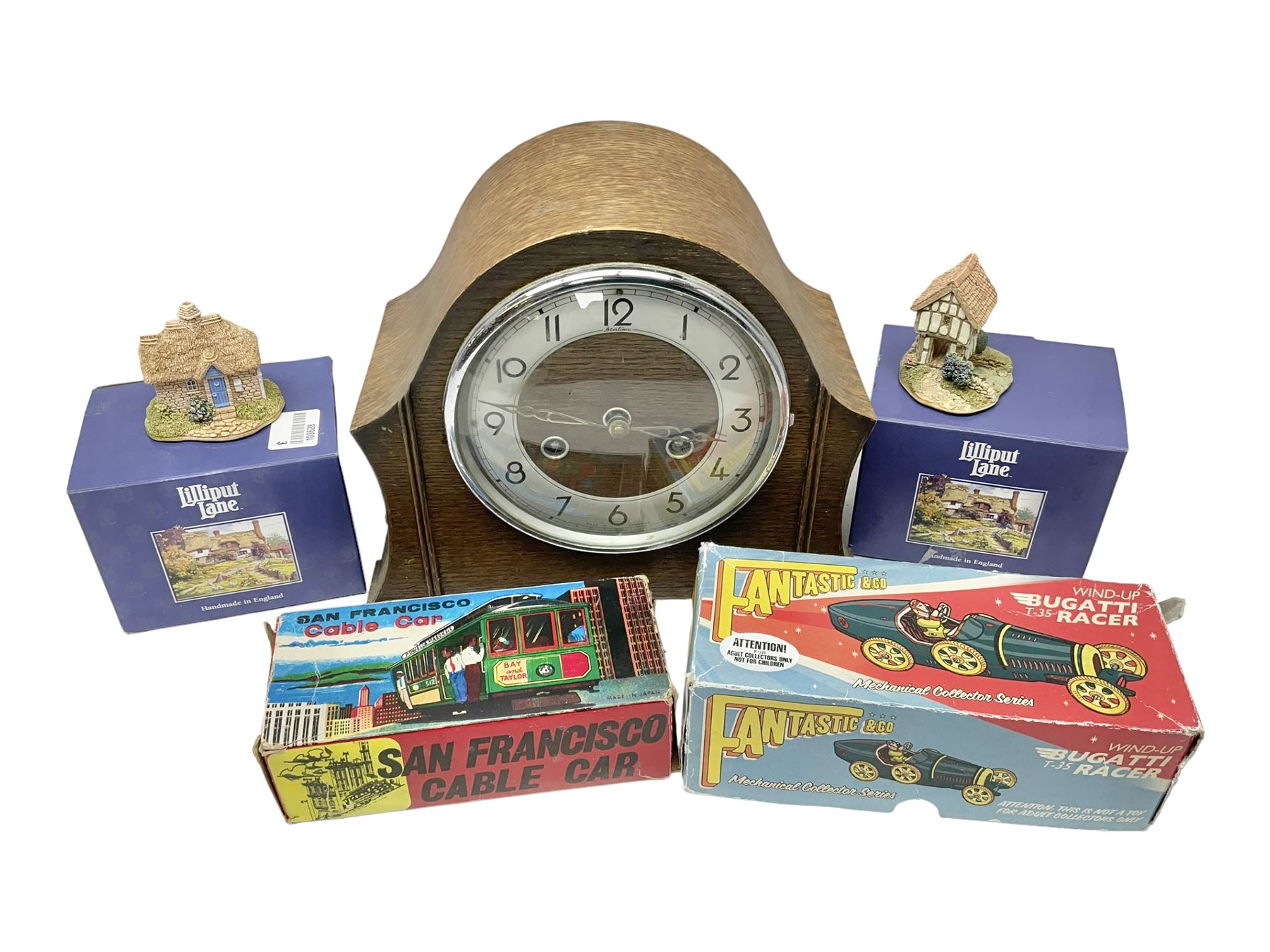 Oak cased mantel clock, two boxed Lilliput Lane cottages and two boxed tin-plate toys