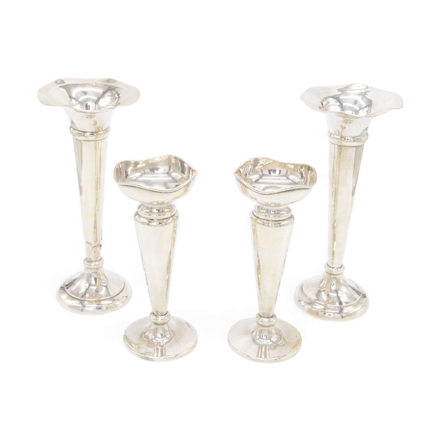 Two pairs of early 20th century silver vases, comprising pair of Edwardian trumpet vases with fluted rims upon a circular domed foot, hallmarked S Blanckensee & Son Ltd, Chester 1907, and a smaller 1920s pair, hallmarked Chester 1920, maker's mark worn and indistinct, tallest H19cm