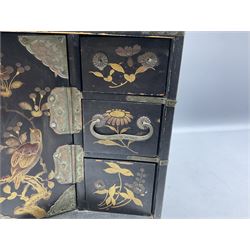 Late 19th/early 20th century Japanese table top cabinet, decorated ornately in gilt with birds and blossoming branches, the two hinged doors to the centre opening to reveal compartmented letter rack interior flanked by various long and short drawers (a/f), H32cm