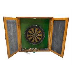 Dart board in wooden cabinet