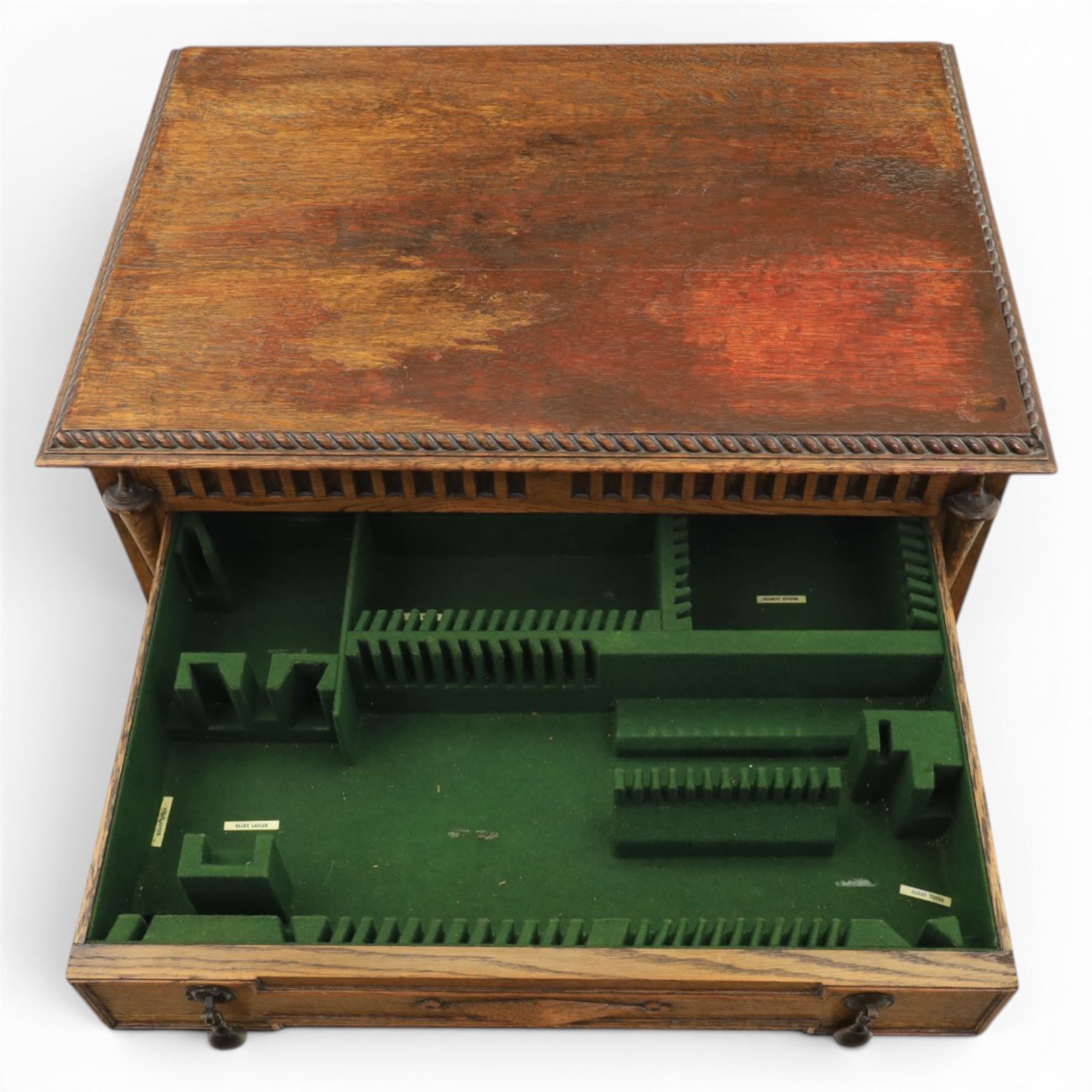 Early 20th century oak cased canteen on barleytwist stand, hinged top with fitted baized lined interior, above a drawer fitted for cutlery
