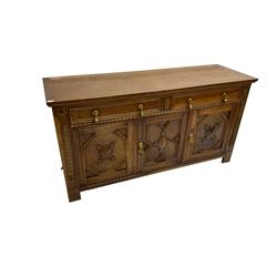 Early 20th century oak sideboard, fitted with two drawers over three cupboards, decorated with half turned mounts