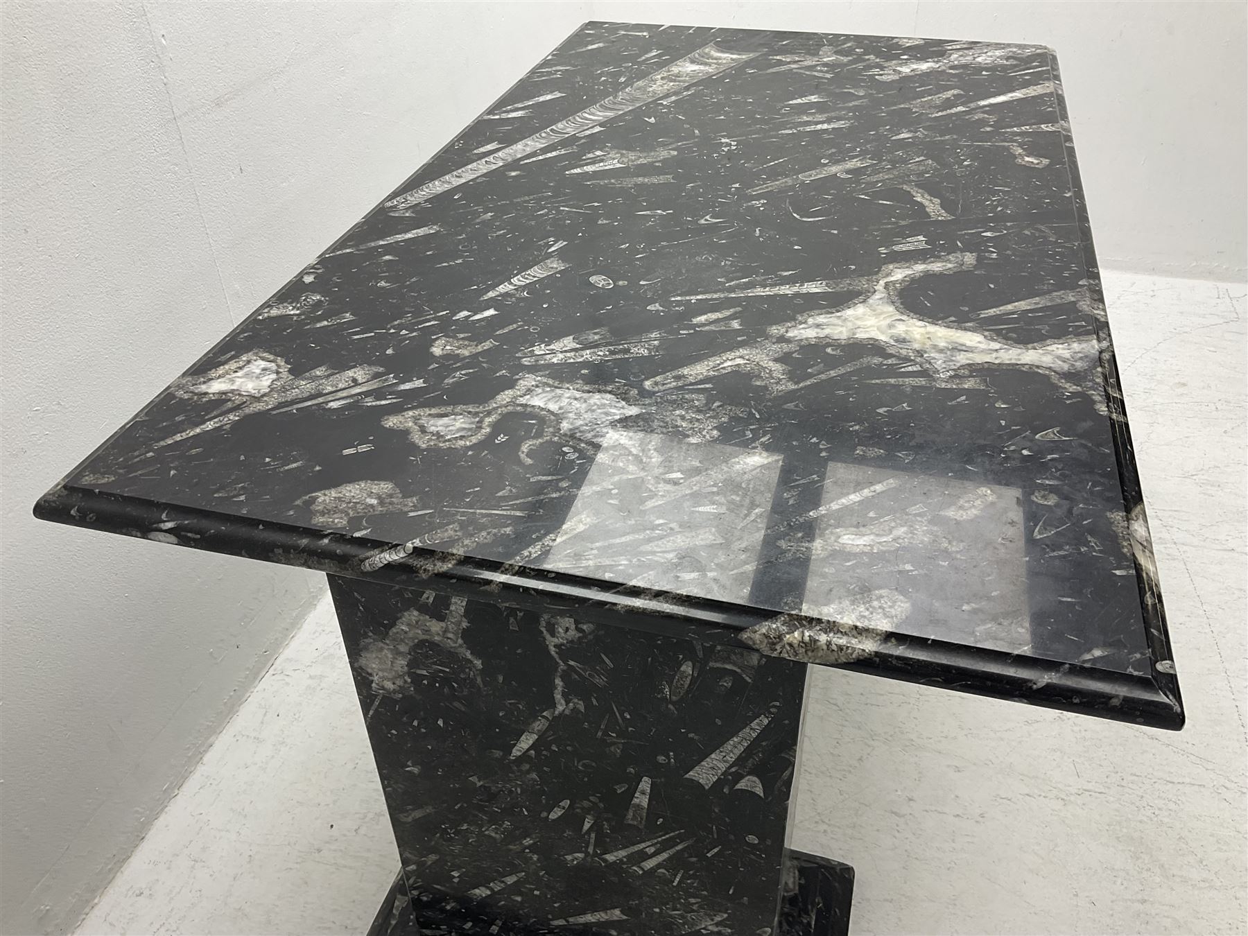 Marble hall table with orthoceras and goniatite inclusions, the rectangular top upon two rectangular stepped plinths, H75cm, L135cm, D78cm 