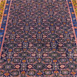 North West Persian Bidjar hand-knotted runner, decorated with an all-over herati pattern on a deep indigo ground, the field is filled with a repeating diamond and rosette motifs, interspersed with stylized leaves and floral elements, framed by a border on an ochre ground flanked by contrasting guard borders, with cotton fringe ends 