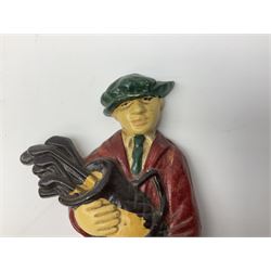 Pair of cast iron Dulux Old English sheepdog doorstops together with another modelled as a golfer