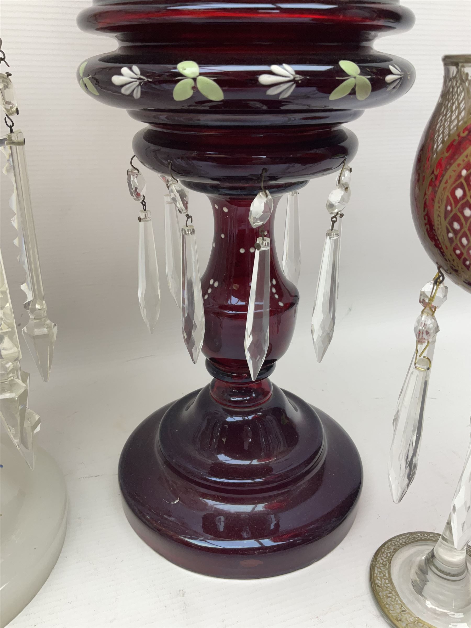 Bohemian red glass lustre, painted with stylised floral and foliate decoration, together with a milk glass example and two bohemian goblets converted to lustres 