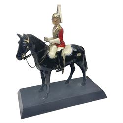 Mounted Lifeguard upon a black horse, in the style of Beswick, upon a wooden plinth, H31cm