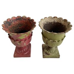 Pair of Victorian cast iron lotus garden urns, the shaped rim over lappet cast underbelly, on moulded footed base