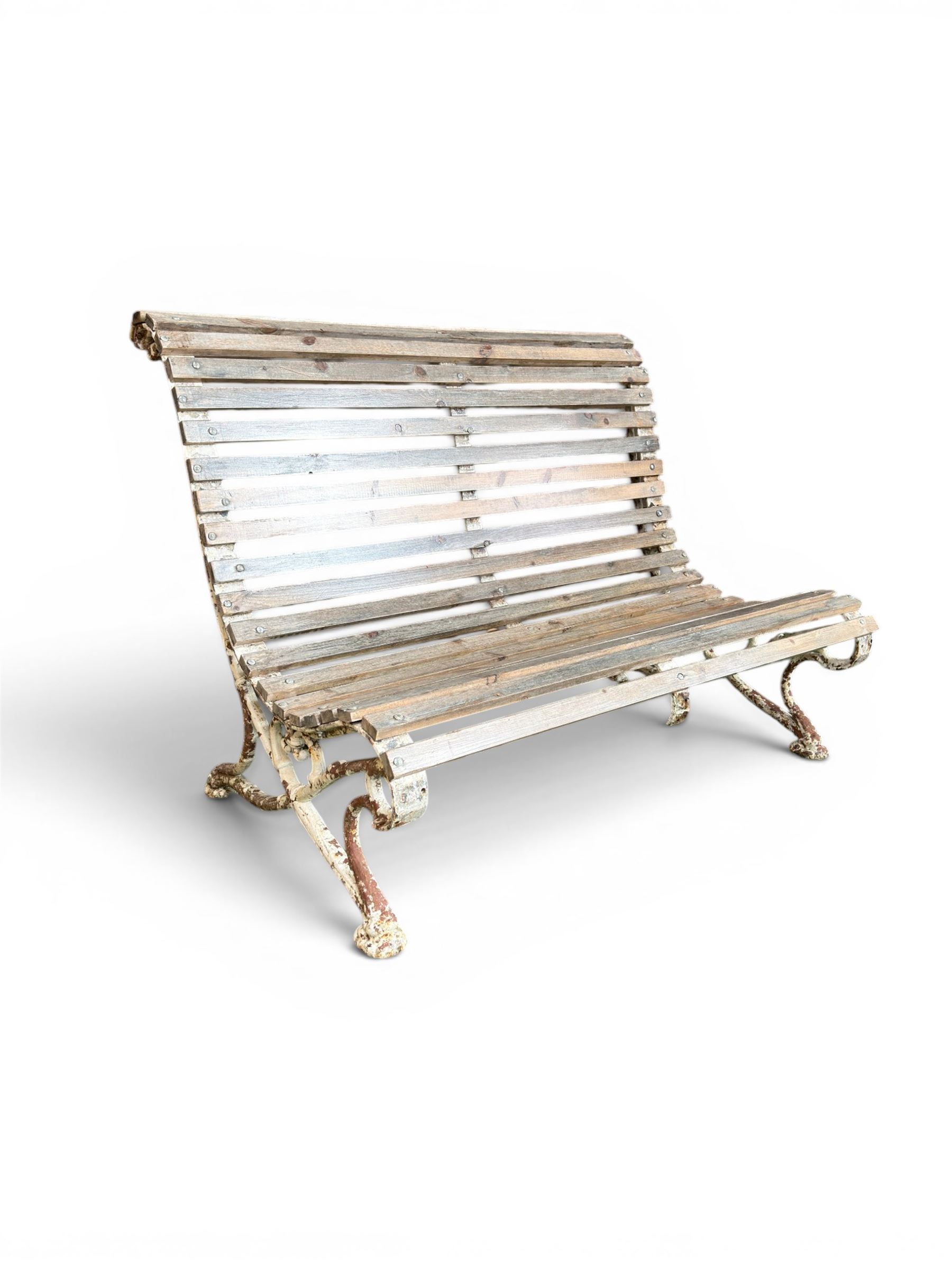 19th century cast iron and wood slatted garden bench, high scroll back form, low X shaped base, finished in distressed white paint