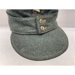 WWII German M43 field cap with 'SS' cloth badge and mountain trooper's edelweiss metal badge