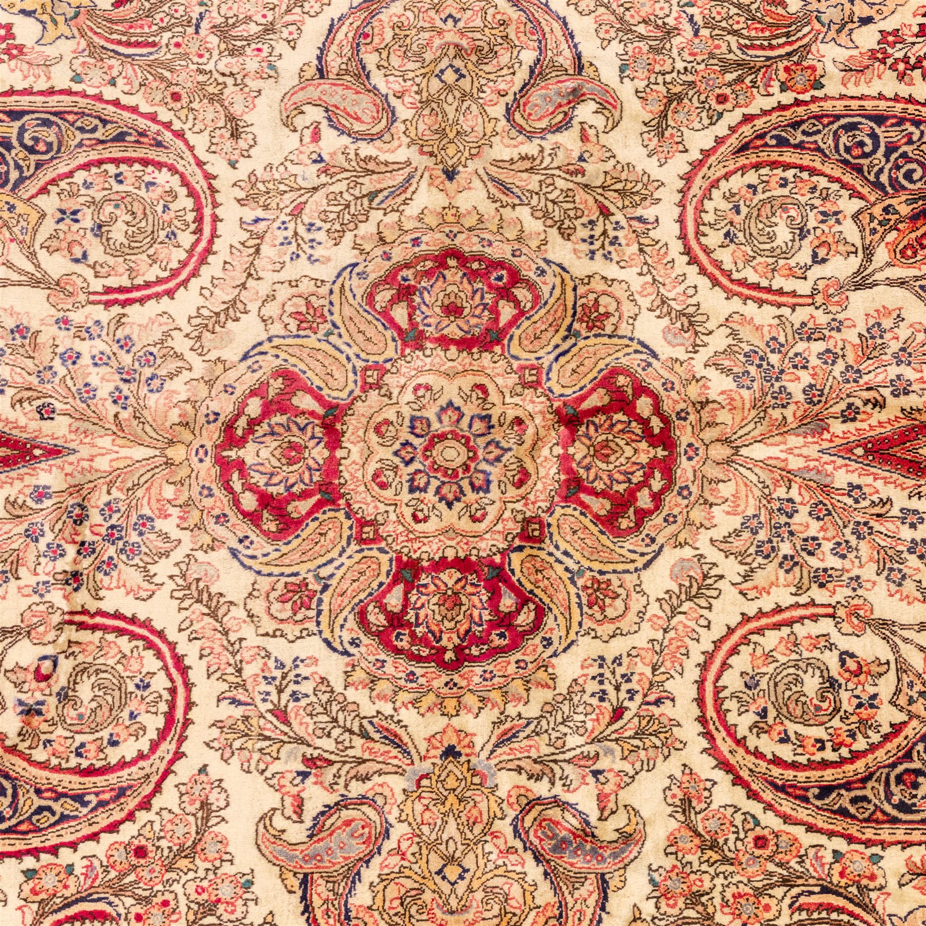 West Central Persian Sarouk hand-knotted carpet, ivory field with central ornate medallion and scrolling vines and palmettes, surrounded by large stylized boteh motifs and flowering foliage, enclosed by a madder-red border of palmettes and floral vine ornament between multiple guard stripes, cotton fringe ends 